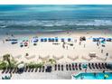 Beach view from condo featuring loungers, umbrellas, ocean, and swimming pool at 107 S Ocean Blvd. # 704, Myrtle Beach, SC 29577