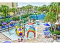 Features a vibrant kiddie pool area with colorful play structures, surrounded by lounge chairs and palm trees at 1105 South Ocean Blvd. # 208, Myrtle Beach, SC 29577