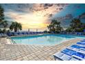 A stunning swimming pool with lounge chairs, set against a breathtaking sunset sky at 1105 South Ocean Blvd. # 208, Myrtle Beach, SC 29577