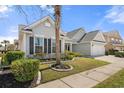 Landscaped front yard with beautiful lawn and flowering tree, inviting curb appeal to a charming home at 1178 Shire Way, Myrtle Beach, SC 29577