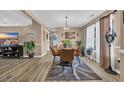 Dining room featuring hardwood floors, a stylish chandelier, and large windows that provide natural light at 171 Talon Dr., Conway, SC 29527