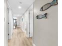Hallway features decorative fish art, leading to bright living area with outside views at 201 74Th Ave. N # 1802, Myrtle Beach, SC 29572