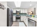 Beautiful kitchen featuring stainless steel appliances, granite counters, and stylish backsplash at 201 74Th Ave. N # 1802, Myrtle Beach, SC 29572
