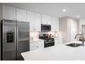 Beautiful kitchen features white cabinets, stainless steel appliances, large countertops, and stylish backsplash at 2078 Nw Parow Ln Nw # B, Calabash, NC 28467