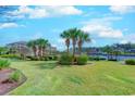 Lush green lawn with mature palm trees and meticulous landscaping creates an inviting atmosphere in this waterfront condo community at 2180 Waterview Dr. # 513, North Myrtle Beach, SC 29582