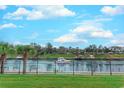 Tranquil water view from the property, enhanced by lush greenery, mature trees, and a secure fence line at 2180 Waterview Dr. # 513, North Myrtle Beach, SC 29582