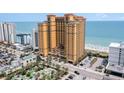 Aerial view of yellow oceanfront condo building, beach, and golf course at 2600 N Ocean Blvd. # 1914, Myrtle Beach, SC 29577