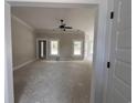 Spacious living room with ample natural light and a ceiling fan, perfect for relaxing and entertaining at 2921 Hughes Gasque Rd., Aynor, SC 29511