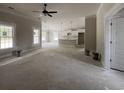 Open-concept living room featuring a view of the kitchen, bathed in natural light from multiple windows at 2921 Hughes Gasque Rd., Aynor, SC 29511