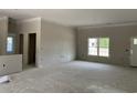Large, unfinished living room featuring ample space, an entry door, and a large window at 2925 Hughes Gasque Rd., Aynor, SC 29511