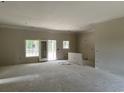 Spacious, unfinished living room boasting lots of natural light and walk-out access to the outdoors at 2925 Hughes Gasque Rd., Aynor, SC 29511
