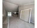 Spacious living room showcasing an open layout, with sliding glass doors, high ceilings and view into the kitchen at 2929 Hughes Gasque Rd., Aynor, SC 29511