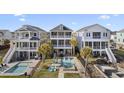 Inviting backyard with a private pool, lounge area, and manicured landscaping at 296 West Palms Dr., Myrtle Beach, SC 29579