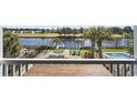 Backyard view overlooking manicured lawn, spa, in-ground pool, and distant waterway at 296 West Palms Dr., Myrtle Beach, SC 29579