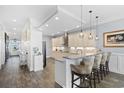 Bright kitchen featuring granite countertops, stainless steel appliances, pendant lighting, and wood flooring at 296 West Palms Dr., Myrtle Beach, SC 29579