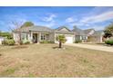 Attractive single-story home with a manicured lawn and a young palm tree in the front yard at 321 Galway Ct., Longs, SC 29568