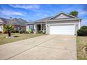 Single-story home with a large driveway and a well-maintained lawn at 321 Galway Ct., Longs, SC 29568