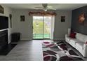 Cozy living room with a fireplace and a sliding door to a balcony with a view at 380-K Myrtle Greens Dr. # 380-K, Conway, SC 29526