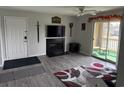 Inviting living room with a fireplace, TV, and access to a balcony with a lake view at 380-K Myrtle Greens Dr. # 380-K, Conway, SC 29526