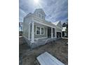 New construction home with a covered front porch, white columns, and green siding at 382 Waties Dr., Murrells Inlet, SC 29576