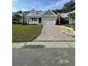 Charming one-story home with a two-car garage, manicured lawn, and brick paver driveway at 382 Waties Dr., Murrells Inlet, SC 29576