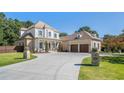 Long driveway leading to a beautiful home with a well-manicured lawn and mature trees at 404 Club Dr., Myrtle Beach, SC 29572
