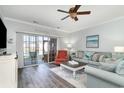 Comfortable living room featuring a ceiling fan, stylish furniture, and sliding glass doors to the outdoor patio at 4136 Hibiscus Dr. # 102, Little River, SC 29566
