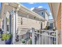 Cozy outdoor patio area with neutral siding, white railing and various decorative elements, perfect for relaxation at 4350 Grande Harbour Blvd., Little River, SC 29566
