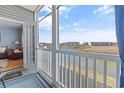 Enjoy this screened-in patio with a peaceful waterfront view and comfortable seating at 4503 W Harbour Ct. # S-12, Little River, SC 29566