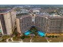 Aerial view of a complex, featuring a large swimming pool area surrounded by resort buildings at 4800 S Ocean Blvd. # 1418, North Myrtle Beach, SC 29582