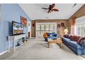 A living room showcasing the couch, rug, ceiling fan, and access to the porch at 4814 Innisbrook Ct. # 412, Myrtle Beach, SC 29579
