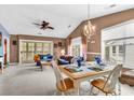 An open-concept living space with a dining table and access to an outdoor patio at 4814 Innisbrook Ct. # 412, Myrtle Beach, SC 29579