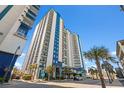 Tall condo building showcasing multiple balconies and a modern blue and white design at 504 N Ocean Blvd. # 401, Myrtle Beach, SC 29577