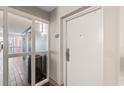 Hallway view of condo entrance showing a white door and view of the elevator at 504 N Ocean Blvd. # 401, Myrtle Beach, SC 29577