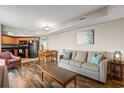 Comfortable living room showcasing sleek wood floors, a sofa, and a glimpse of the kitchen at 504 N Ocean Blvd. # 401, Myrtle Beach, SC 29577