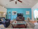 Comfortable living room with stylish decor, bright accent wall, and hardwood floors at 511 Mattamushkeet Dr., Little River, SC 29566