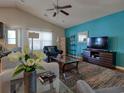 Cozy living room with natural light, modern furniture, and vibrant accent wall at 511 Mattamushkeet Dr., Little River, SC 29566