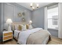 Stylish bedroom featuring paneled accent wall, elegant chandelier, and plush bedding at 512 9Th Ave. S, North Myrtle Beach, SC 29582