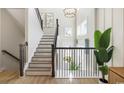 Bright entryway featuring a staircase with wood trim, modern chandelier, and ample natural light at 512 9Th Ave. S, North Myrtle Beach, SC 29582