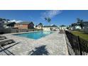 Community outdoor pool featuring a spacious sundeck, lounge chairs, and an outdoor gazebo, perfect for relaxation at 512 9Th Ave. S, North Myrtle Beach, SC 29582