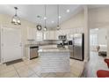 Bright kitchen with white cabinets, granite countertops, stainless steel appliances, and a center island at 514 Vallecrosia Ct., Little River, SC 29566