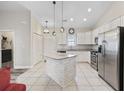 Bright kitchen with white cabinets, granite countertops, stainless steel appliances, and center island at 514 Vallecrosia Ct., Little River, SC 29566