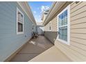 A private side yard with well-maintained siding and an outdoor grill at 514 Vallecrosia Ct., Little River, SC 29566