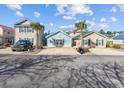 Charming exterior view of colorful coastal homes with palm trees and private driveways during daytime at 514 Vallecrosia Ct., Little River, SC 29566