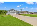 A view of a home exterior with green lawn and long driveway at 515 Goldstar St., Conway, SC 29526