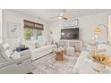 Cozy living room featuring white couches, large windows, woven shades, and modern decor at 515 Goldstar St., Conway, SC 29526