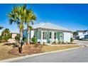 Attractive beach house features a covered front porch, Adirondack chairs, and well-maintained landscaping at 5223 Sea Coral Way, North Myrtle Beach, SC 29582