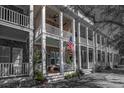 Inviting porch with American flag, featuring a cozy seating area, manicured shrubs and a relaxing atmosphere at 730 Farrow Pkwy. # D, Myrtle Beach, SC 29577