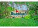 Meadowlands Golf Club sign surrounded by lush greenery at 1017 Meadowlands Trail, Calabash, NC 28467