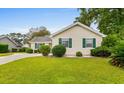 Well maintained home featuring green shutters, vinyl siding, and a manicured lawn at 1202 Formby Ct., Myrtle Beach, SC 29588